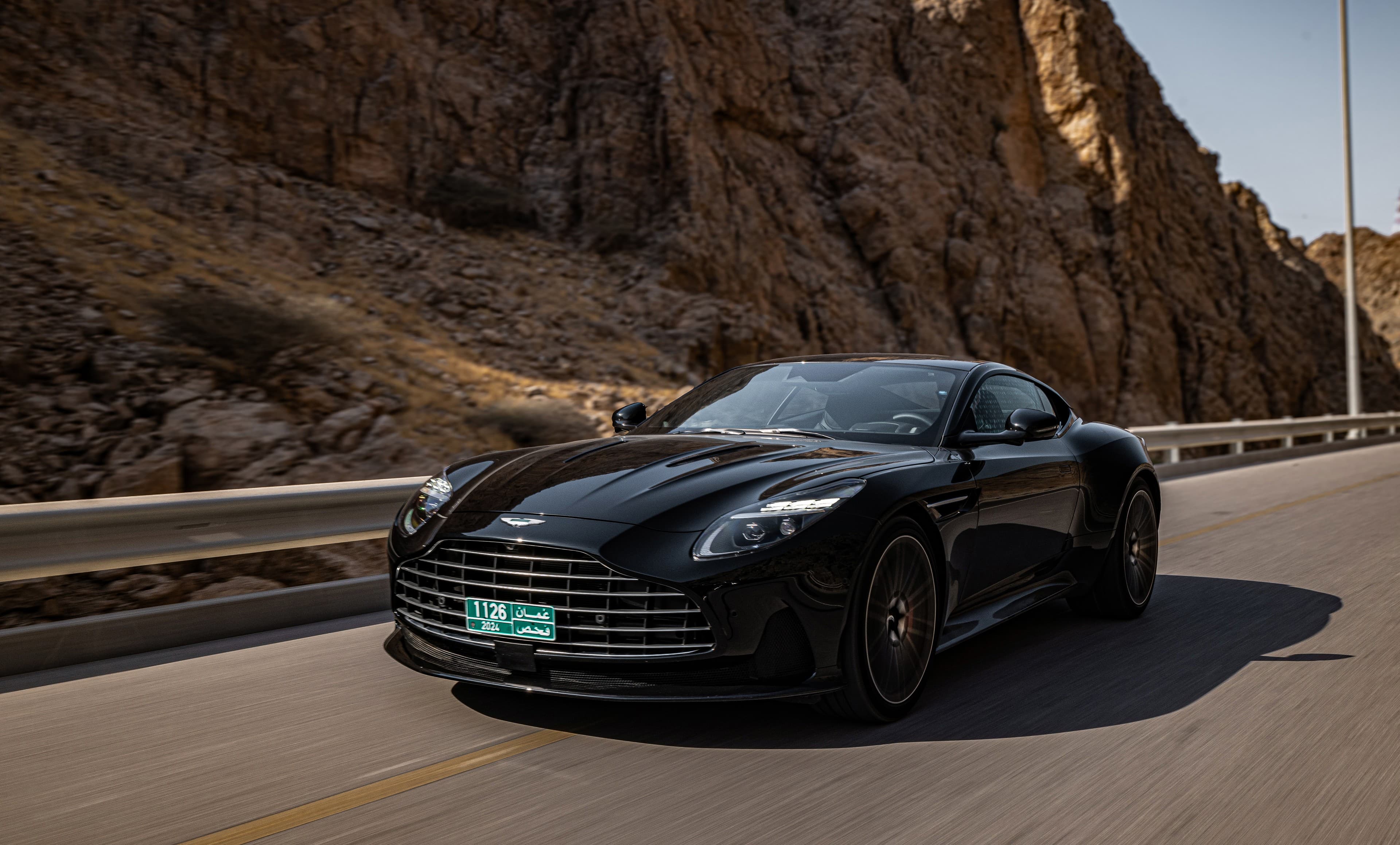 Aston Martin front rolling through canyon