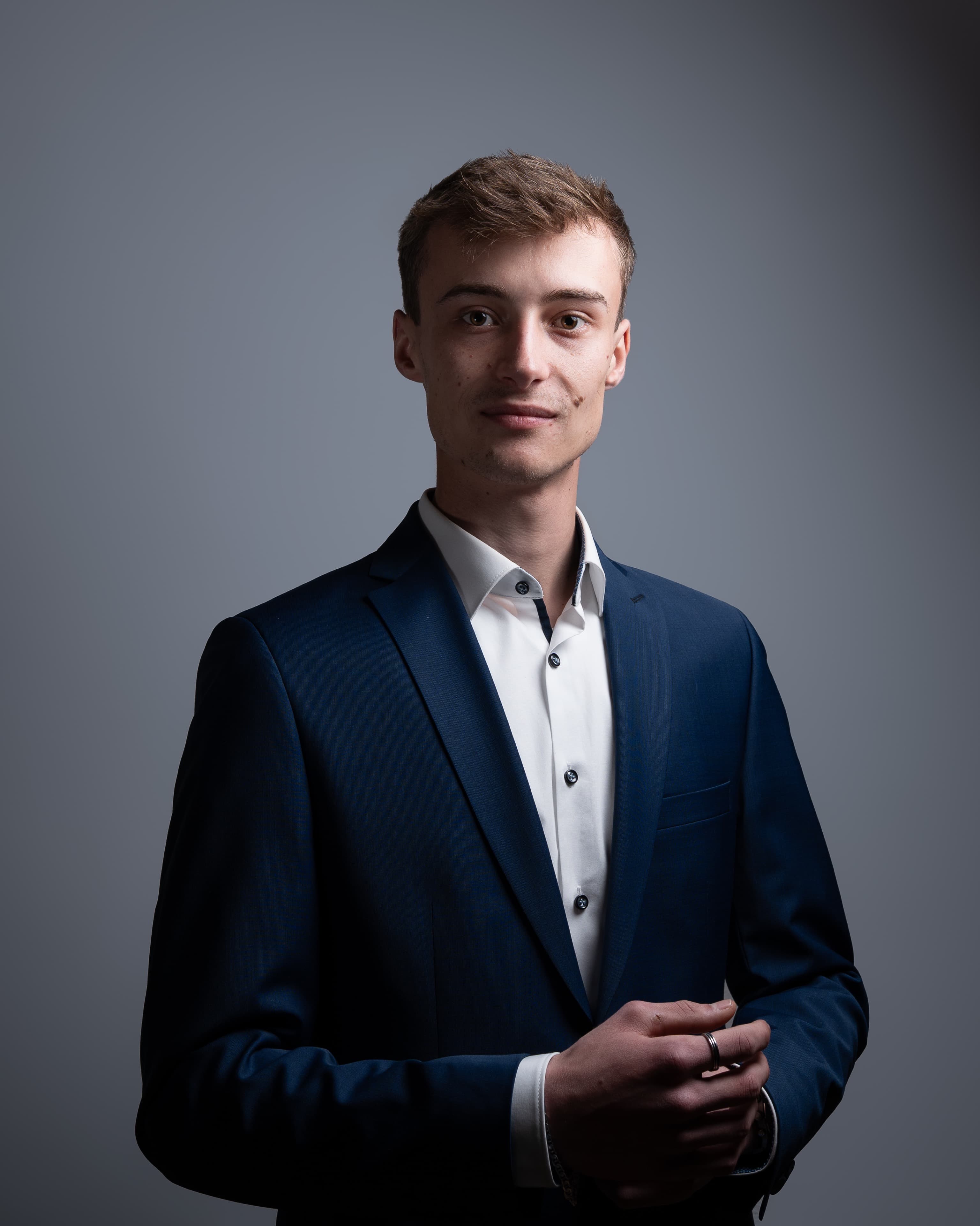 Executive headshot in a navy suit