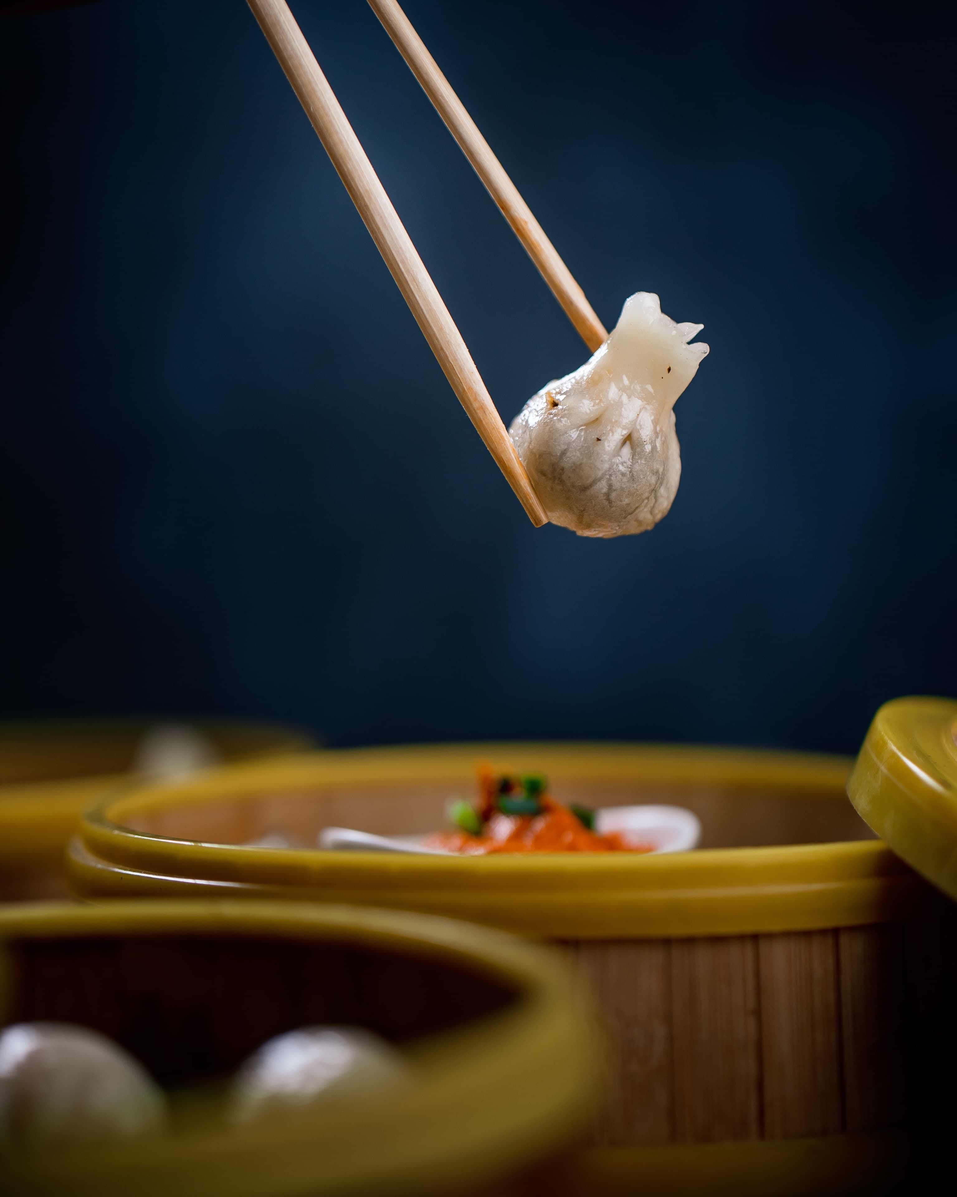 Steamed bao dumplings in a bamboo basket, overhead