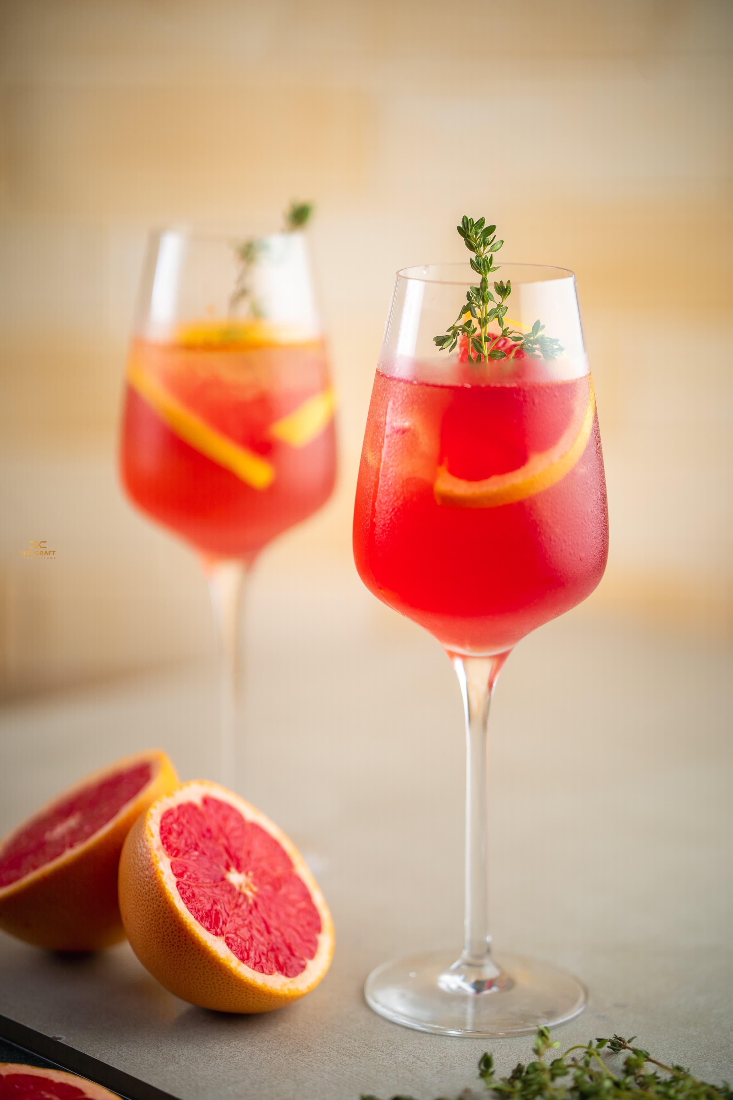 Grapefruit spritz cocktails garnished with thyme and citrus