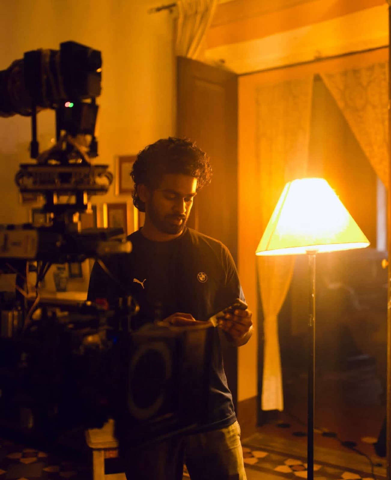 David checking a frame beside the cinema camera on a film set