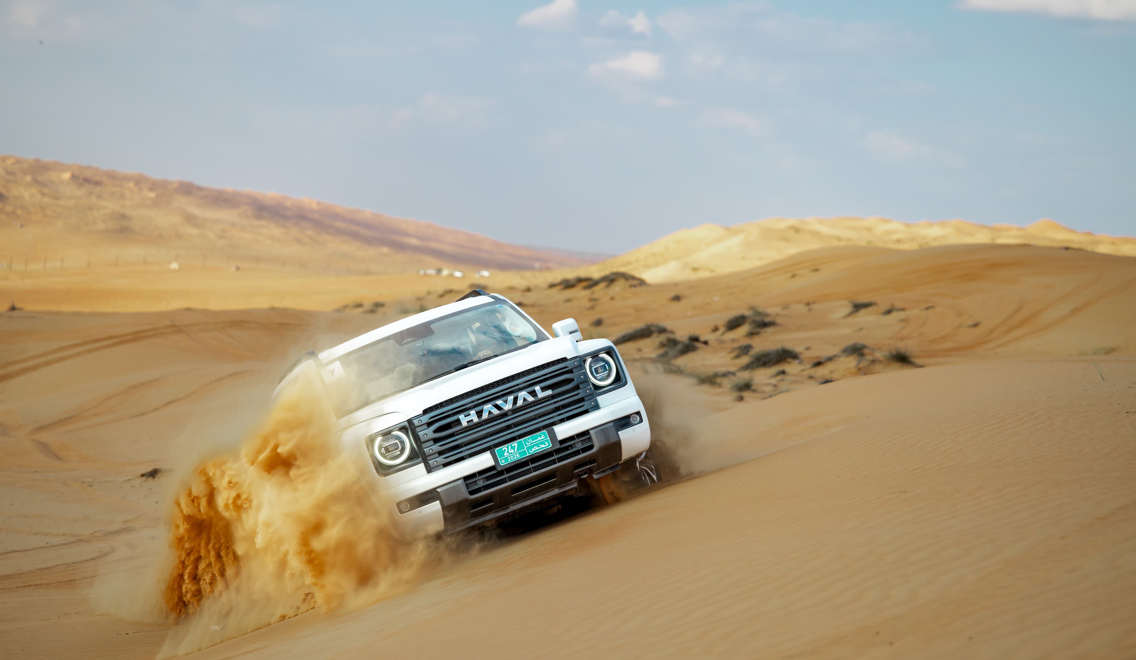 SUV climbing through soft desert sand