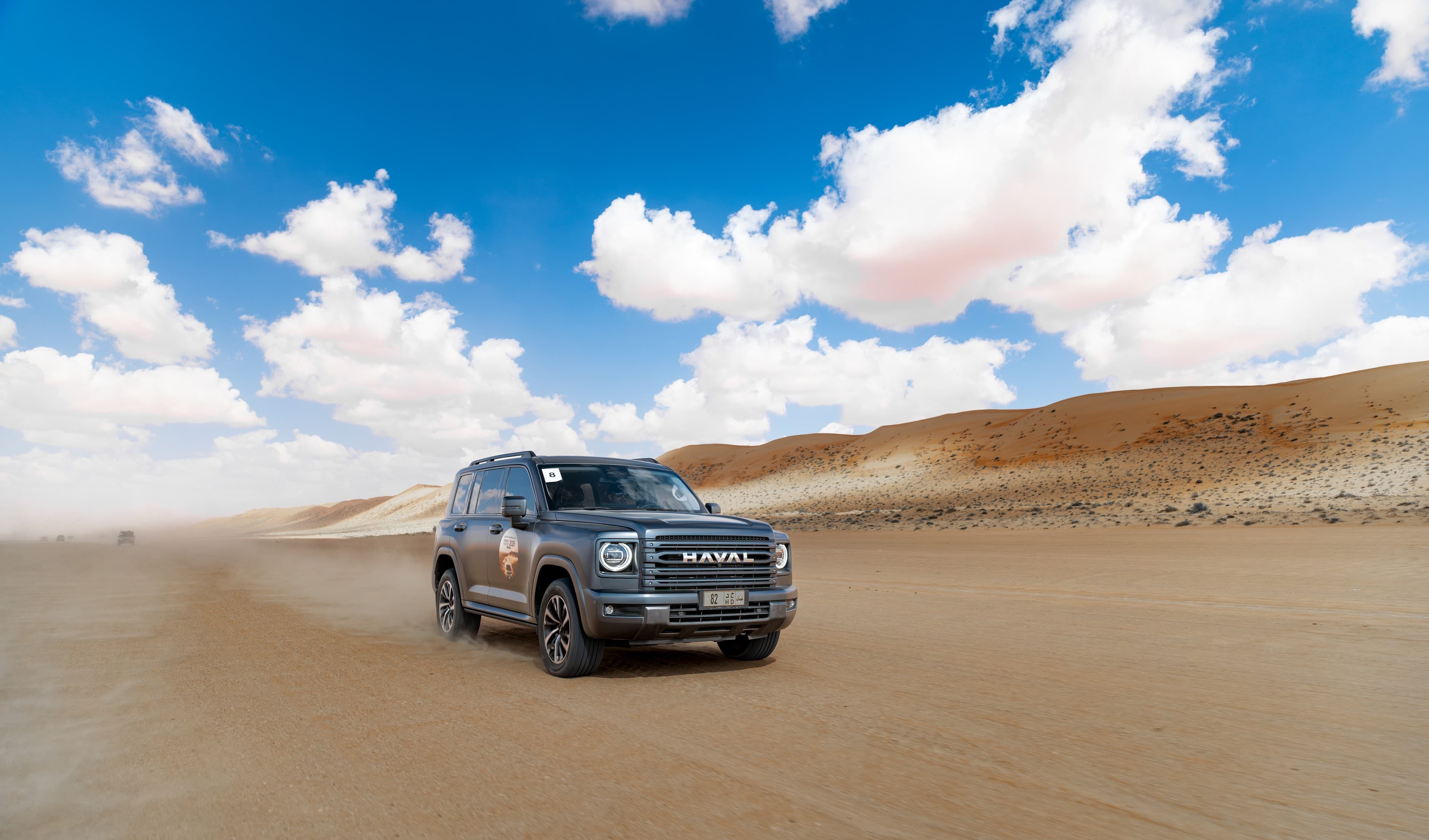 SUV moving across open desert