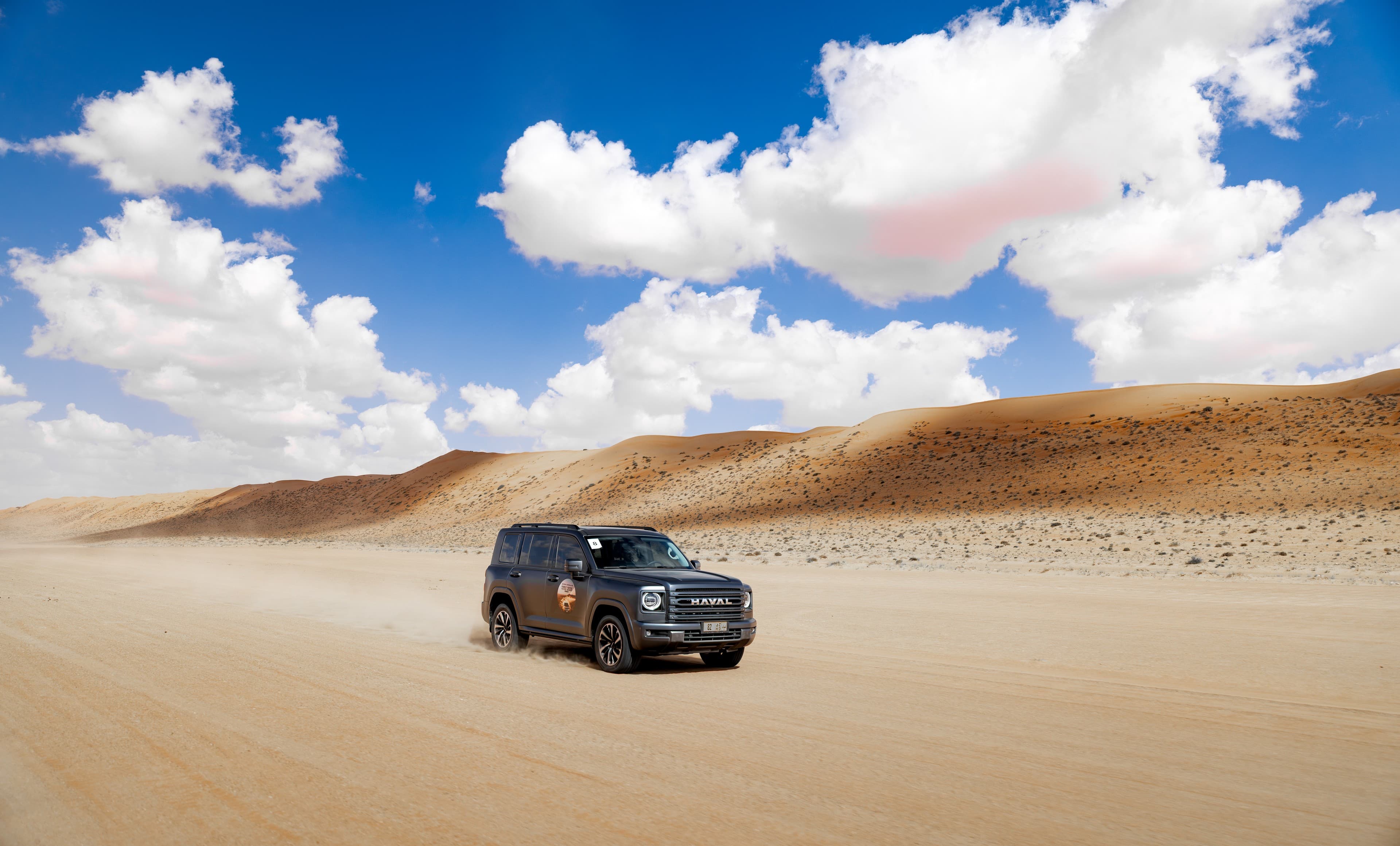 SUV moving through open desert